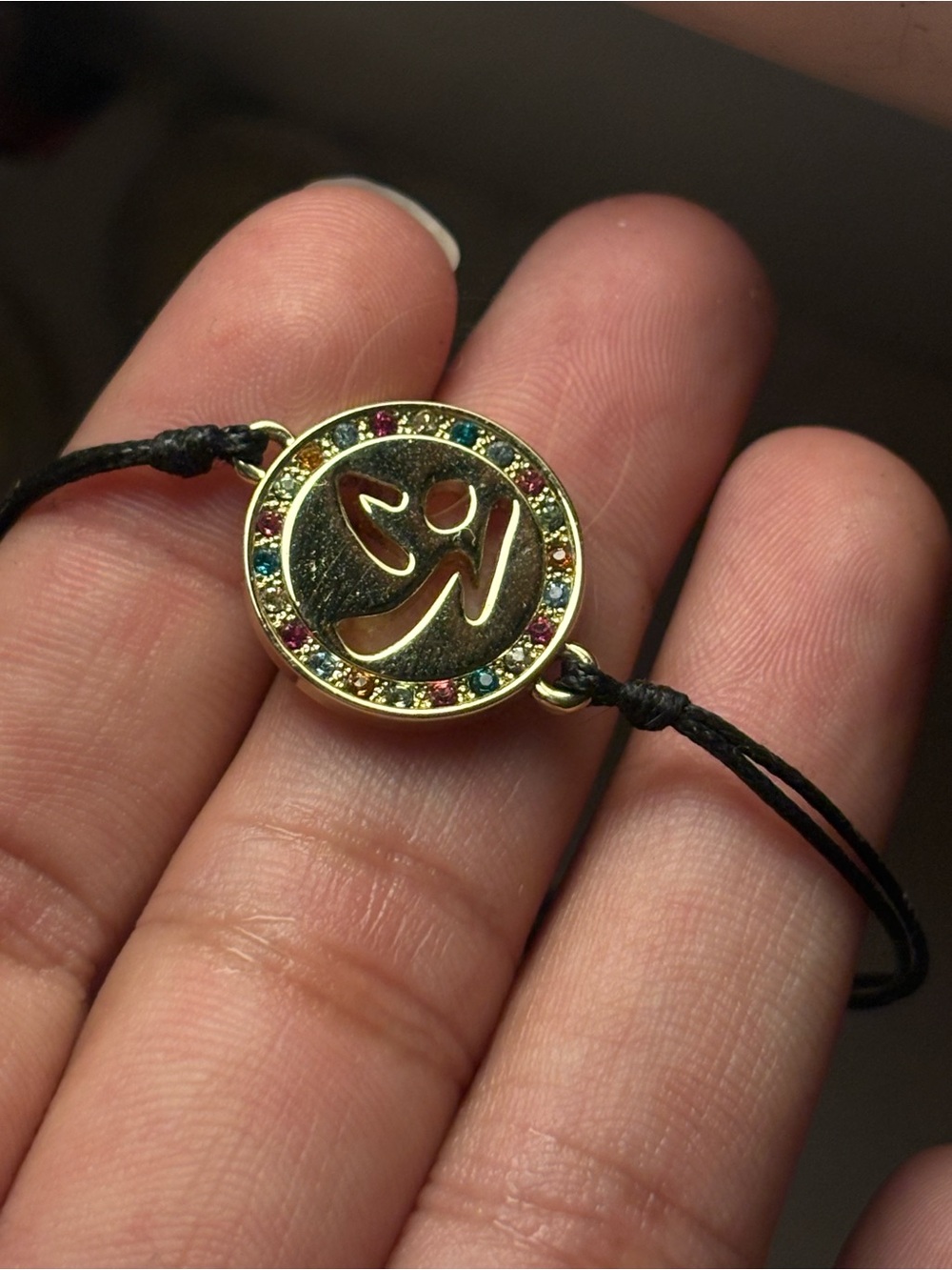 Zumba Fitness Gold Om Pendant Bracelet with Multicolor Crystals and Black Cord